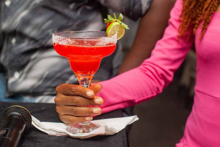 lady holding a pink cocktail
