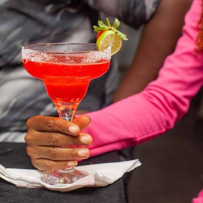 lady holding a pink cocktail